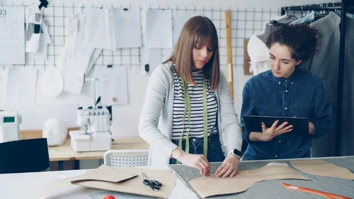 Two fashion designers work in a design studio.